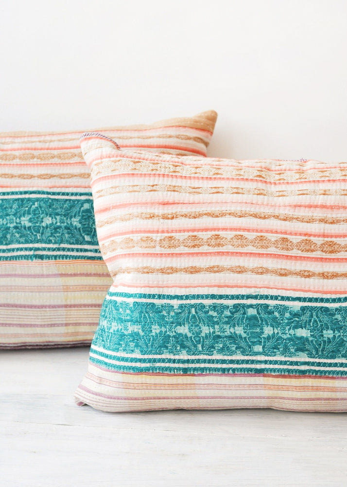 1: Two multicolored pillows made of vintage quilts.