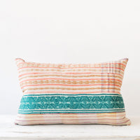 2: A multicolored pillow made of vintage quilt fabric.