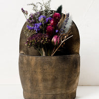 2: A wooden wall basket housing dried flowers.
