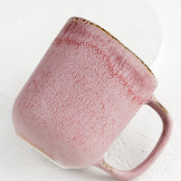2: A purple ceramic mug with mottled glaze appearance.