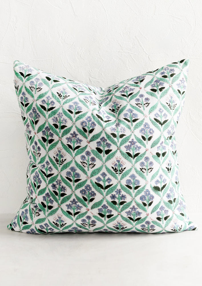 A block print pillow in mint and periwinkle botanical print.
