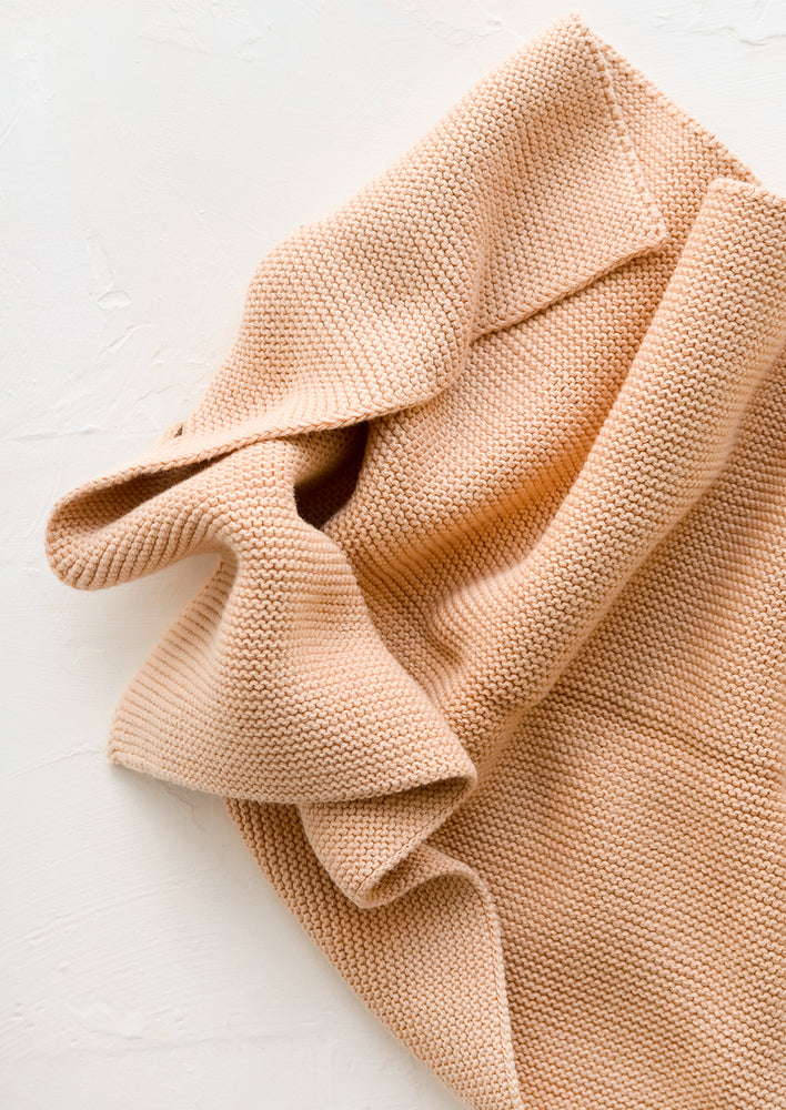 A knit cotton dish towel in dusty peach.