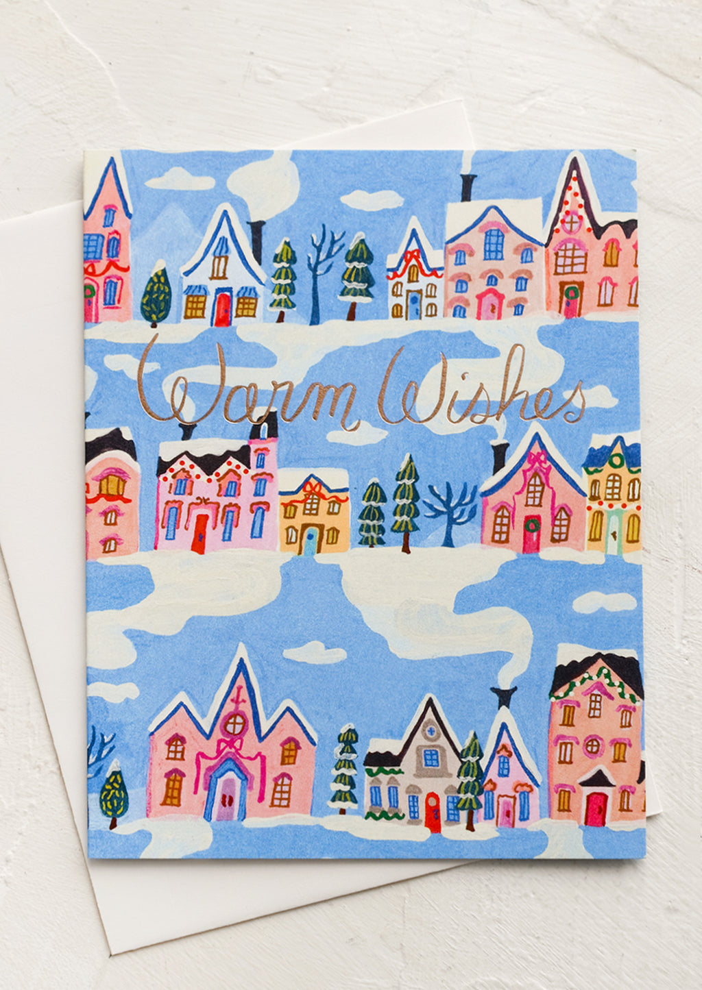 2: Greeting card with blue background and repeating rows of houses and trees. "Warm Wishes" written in copper script.