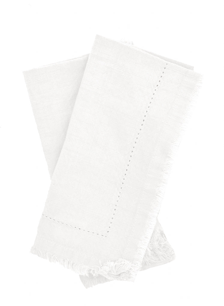 Parchment: Two folded ivory Cotton Napkins with frayed edges .