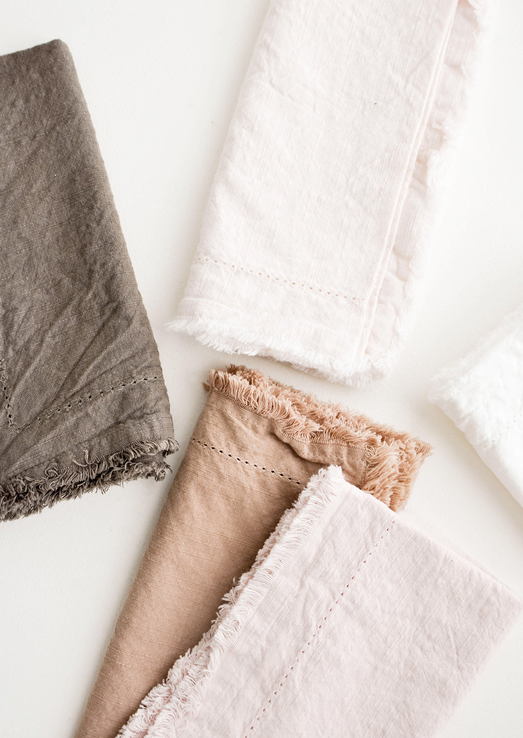 2:  Cotton Napkins with frayed edges in browns and pinks.