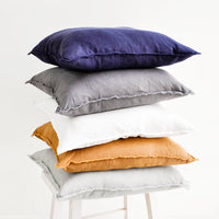 White: Stacked Image of Square Linen Throw Pillows with Frayed Trim