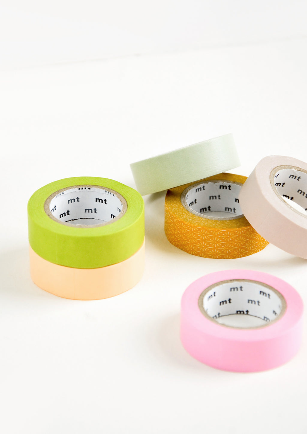 1: An assortment of washi tape rolls in a mix of colors and patterns.