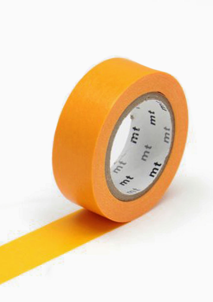 A roll of washi tape in carrot orange.