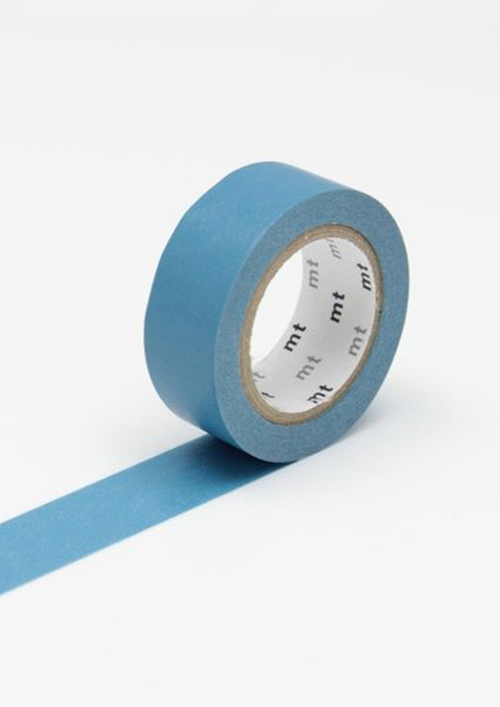 A roll of washi tape in solid medium blue color.