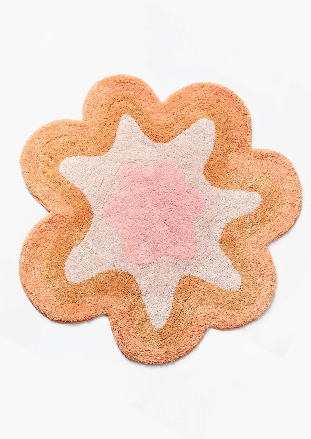 Pink / Caramel Multi: A wavy edge flower shaped bath mat in peach and pink.