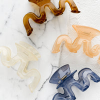 1: Assorted color hair clips in squiggle shape.