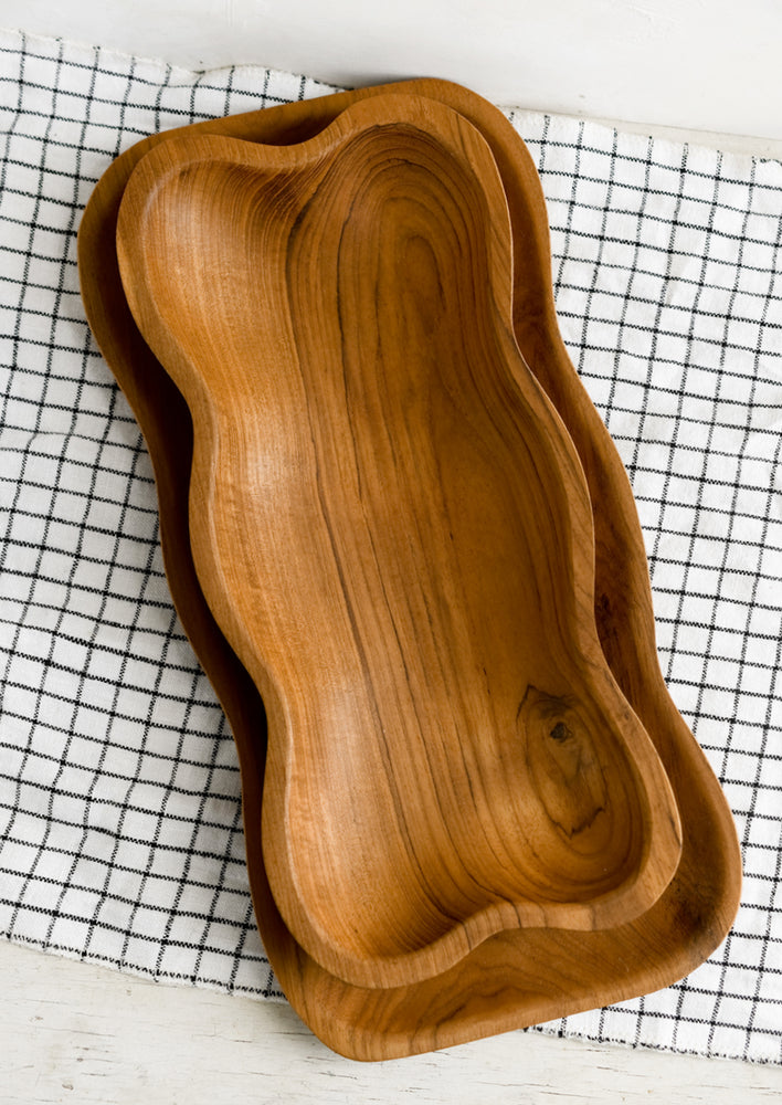1: Rectangular teakwood tray/bowls with wavy edges.