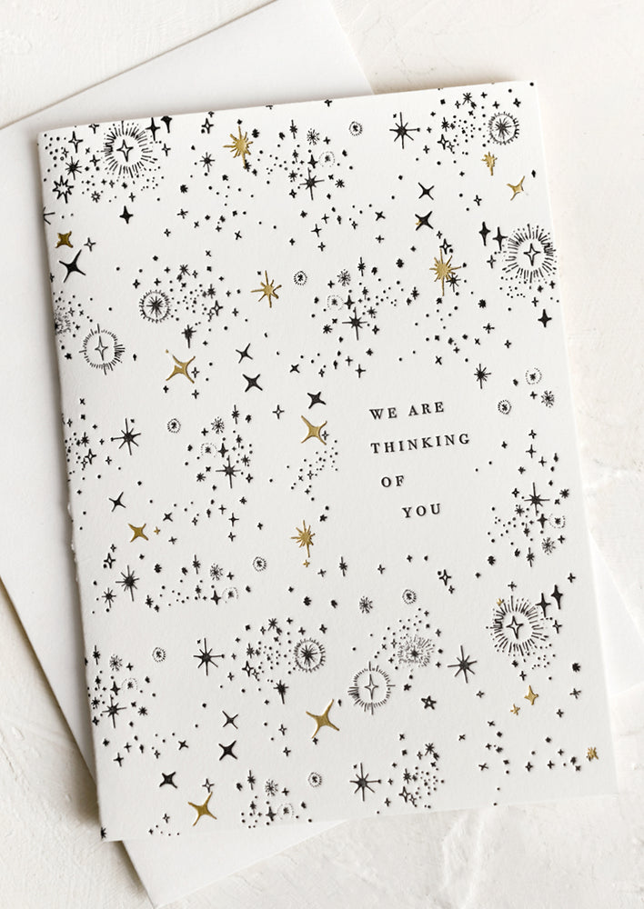 A card with star print reading "We are thinking of you".