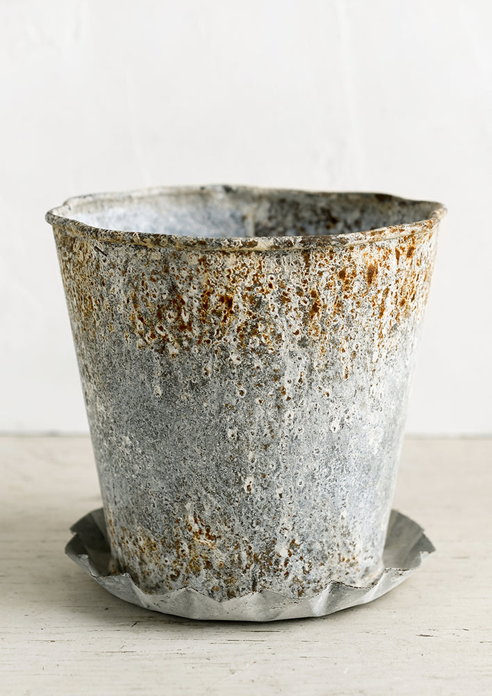 A metal pot with intentional aging.