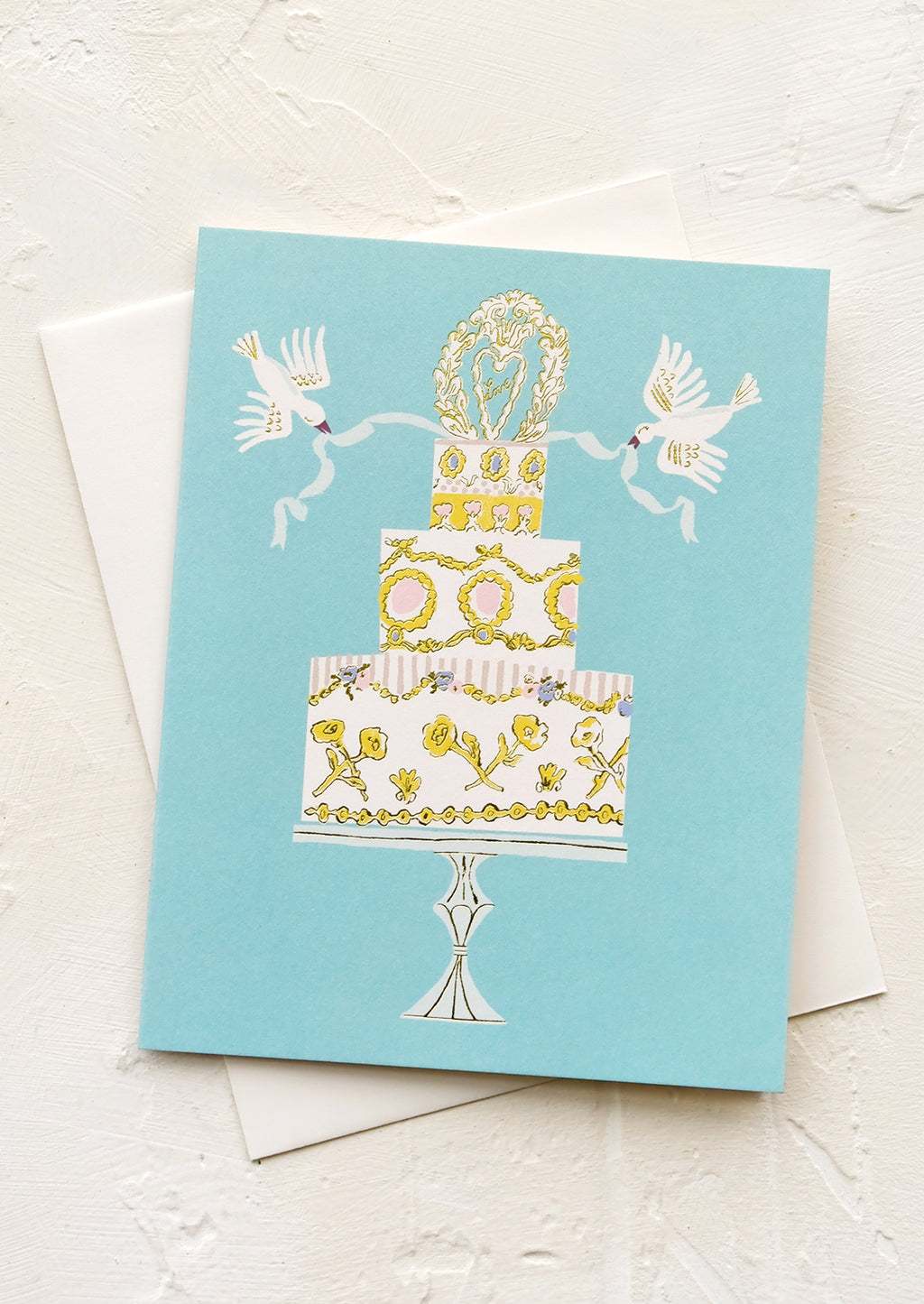1: A greeting card with illustration of wedding cake with doves.