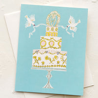 1: A greeting card with illustration of wedding cake with doves.