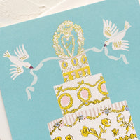 2: A greeting card with illustration of wedding cake with doves.