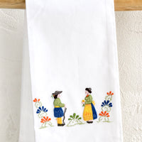 Deutschland: A white folded cotton hand towel with embroidered folk design.