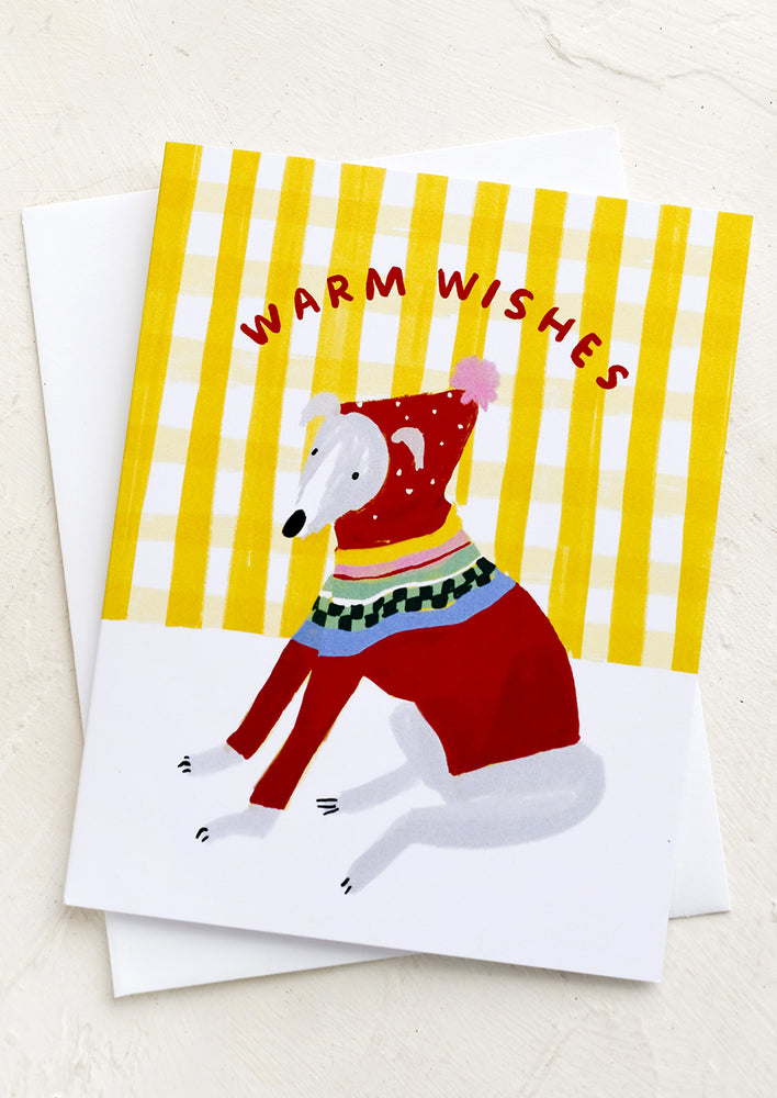 A card with a whippet dog in a christmas sweater, text reads "Warm Wishes".