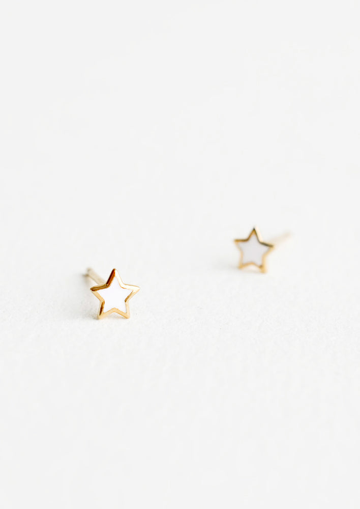1: Star shaped stud earrings in white enamel outlined in yellow gold.