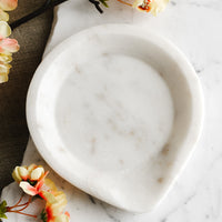 1: A white marble spoon rest with pointed edge.
