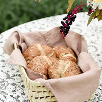 Tea Rose: A woven basket lined with linen tea towel holding croissants.