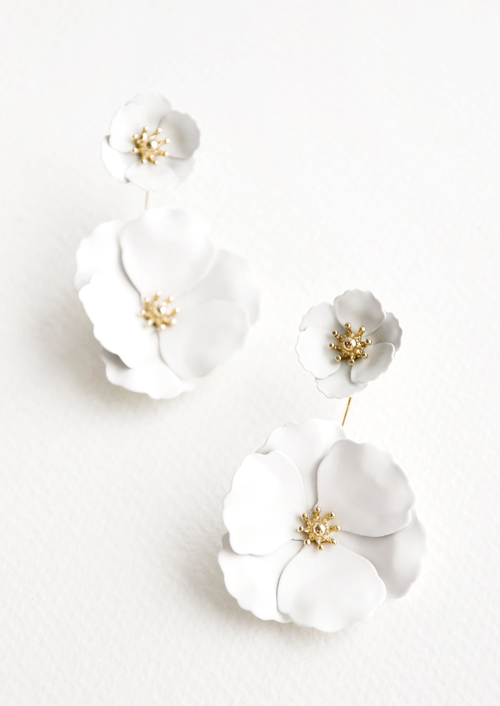 White: Two part true white and gold flower earrings with a small flower post and larger flower drop. 