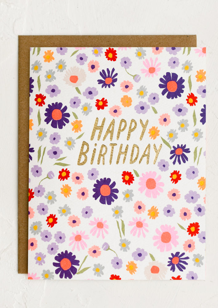 A colorful floral print card with gold "Happy Birthday" text at center.