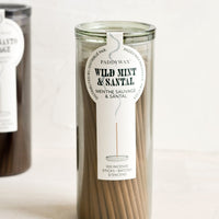 Wild Mint & Santal: A green glass jar with incense sticks in wild mint scent.