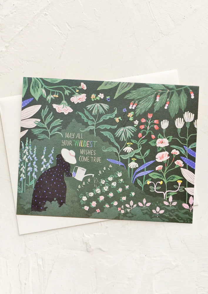 1: A greeting card with an illustration of a woman in a colorful garden and text reading "may all your wildest wishes come true."