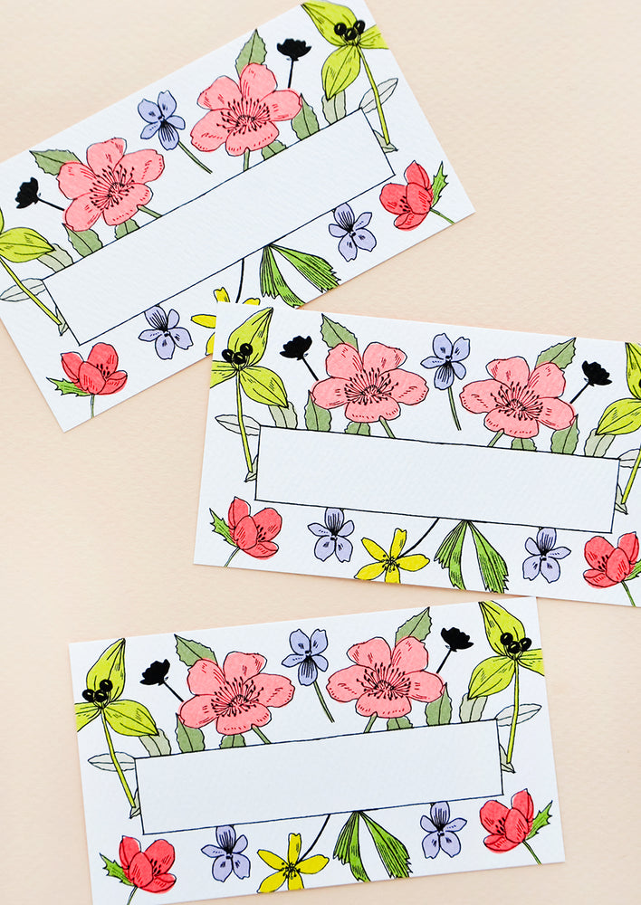 Mini, business card-sized notecards with floral border and area in center for text