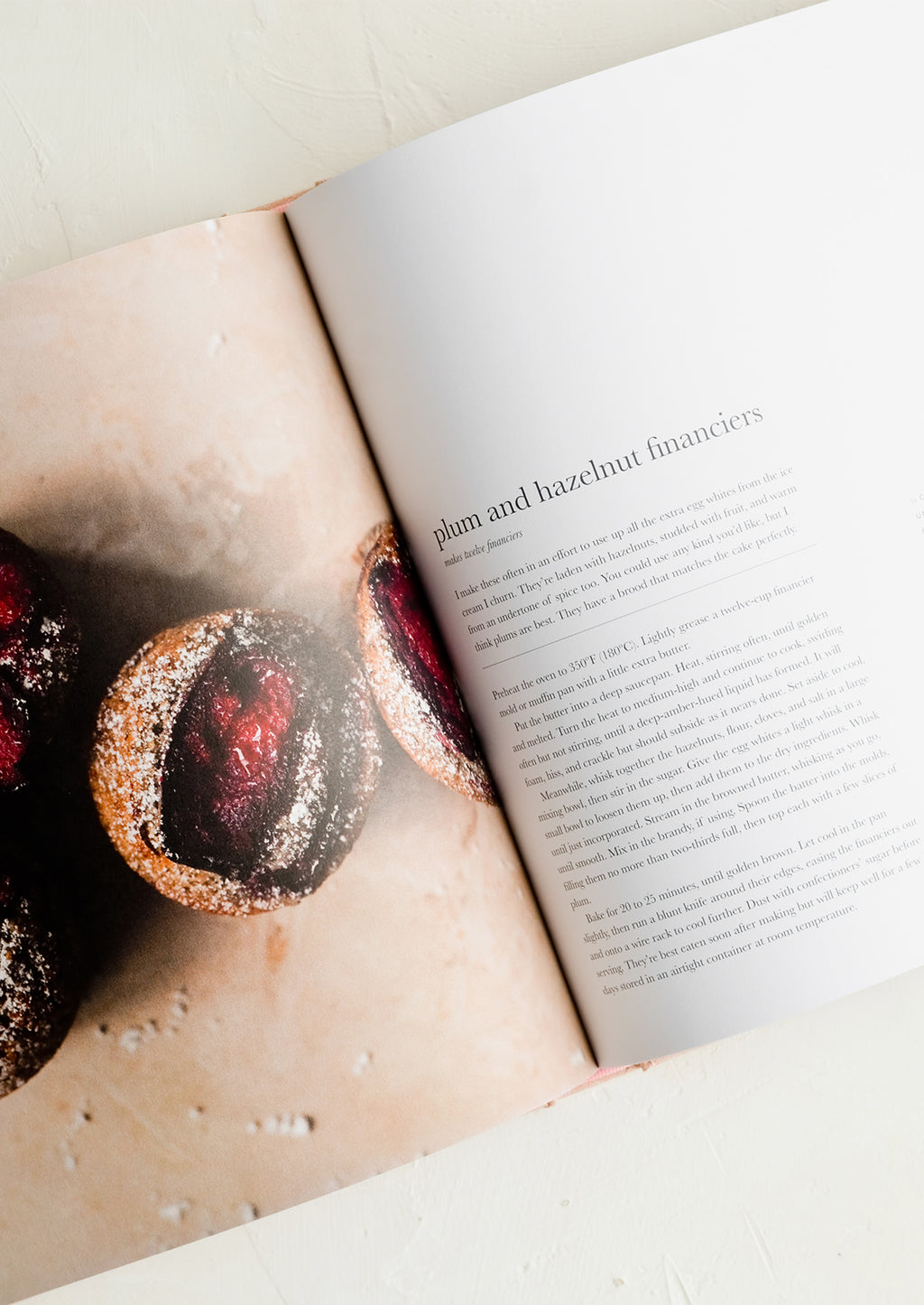 2: A recipe cookbook opened to recipe for plum and hazelnut financiers.