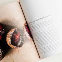 2: A recipe cookbook opened to recipe for plum and hazelnut financiers.