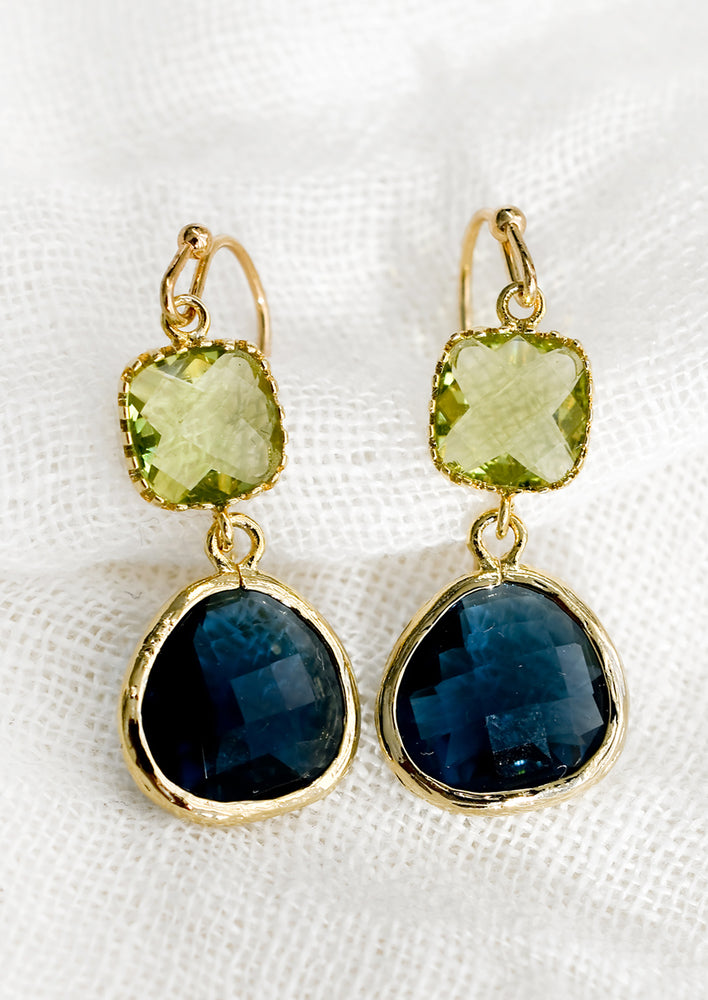 A pair of two-stone bezeled gem earrings in peridot and ocean blue.
