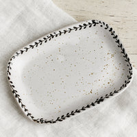 1: A rounded rectangle tray with black leaf motif border.