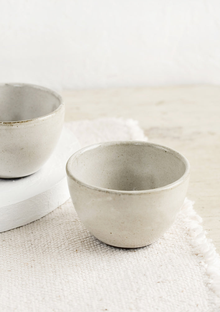Small ceramic pinch bowls in rustic, warm grey ceramic.