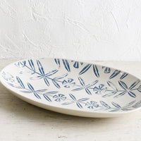 2: An oval shaped ceramic platter with blue imprint design.