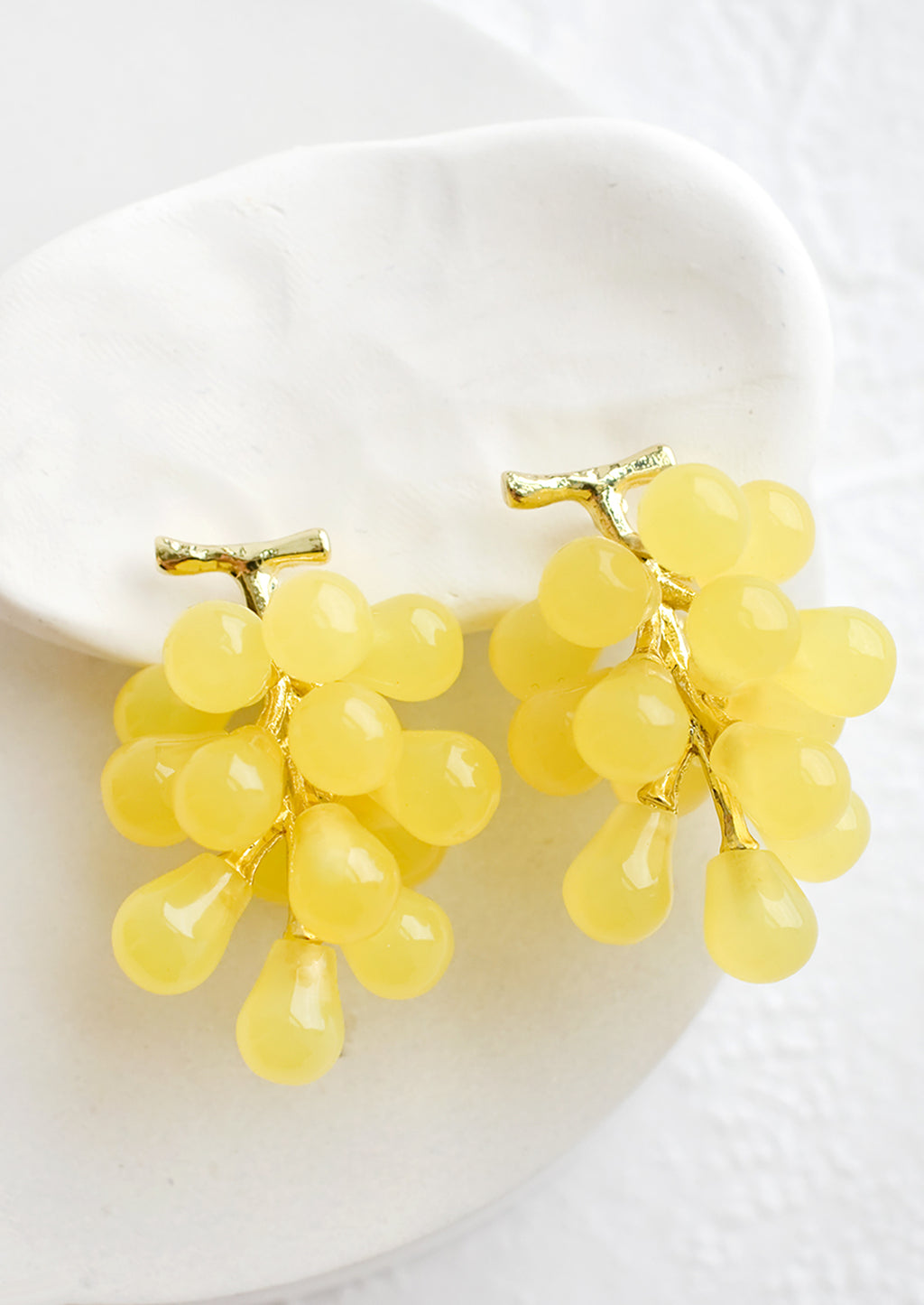 Yellow Grape: A pair of earrings in the shape of green grape bunches.