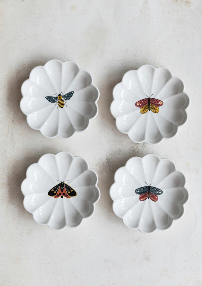 4: Scalloped dishes with insect illustrations.