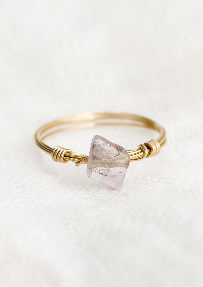 A gold wire wrap ring with diamond-shaped amethyst gemstone.