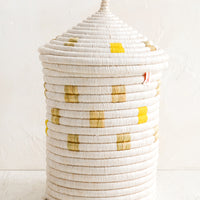 Large [$110.00]: A tall woven basket with gourd-style lid in white with natural and yellow square pattern.