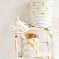 2: Assorted woven lidded baskets in three incremental sizes.
