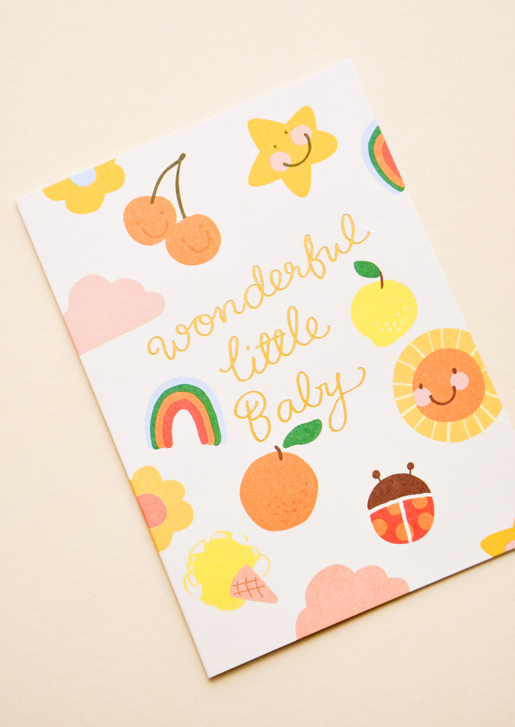 2: Greeting card with illustrated shapes and "Wonderful little baby" written in gold foil. 