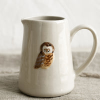 Owl: A small creamer pitcher in natural ivory with owl motif.
