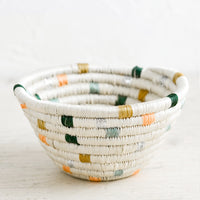 Pastel Dashes: A small woven catchall bowl made from sweetgrass in white with pastel dashes.