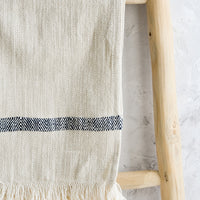 Black Stripe: A woven kitchen towel with black stripe hanging on a ladder.