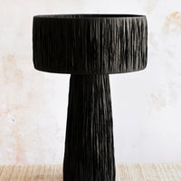 Black: A table lamp wrapped in black raffia.