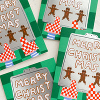 Boxed Set of 8: A card set with illustration of gingerbread men cookies on a tray, text reads "Merry Christmas".