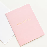 2: A white envelope and pale pink greeting card with "xoxoxoxoxox" in gold foil.