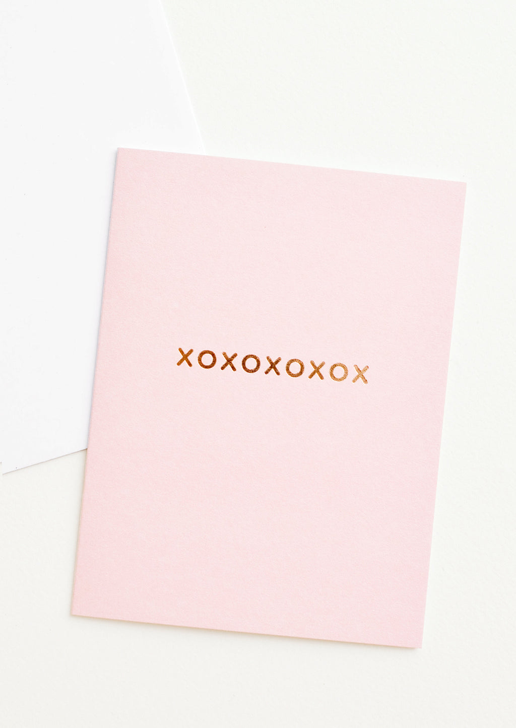 1: A pale pink greeting card with "xoxoxoxoxox" in gold foil.